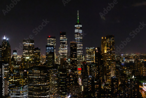 Aerial View of Manhattan Architecture at Night. Evening Shot of Financial Business District from a Helicopter. Scenery of Historic Office Towers, Illuminated Skyscrapers
