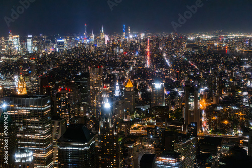Night Aerial Photo with New York City Skyscrapers with Lights in Office Rooms Inside. Helicopter View View Capturing Panorama of Manhattan © Gorodenkoff