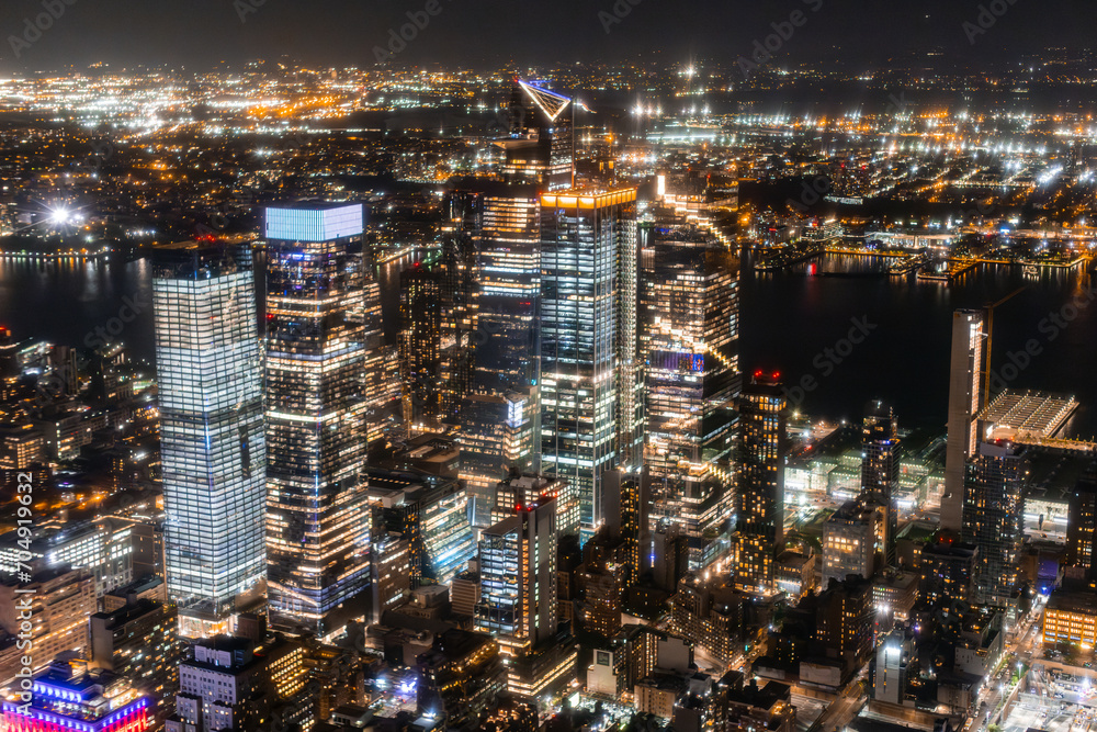 New York City Aerial Night Cityscape with Stunning Manhattan Landmarks, Skyscrapers and Residential Buildings. Wide Angle Panoramic Helicopter View of a Popular Travel Destination