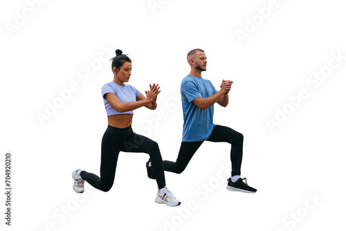 Young tanned female trainer training outside with bearded man in sportswear against transparent background makes lunges. Morning workout at resort. Healthy people, sport, togetherness.