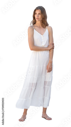 Beautiful young woman in a white summer dress standing barefoot isolated on white background © Martin