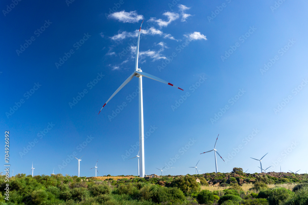 Wind turbine in mountains landscape. Eolic park windpower. Wind farm or New Wind green energy. Wind turbines alternative energy. Windmill power clean electricity generation in Sardinia, Italy