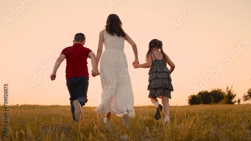 mother runs into sunset holding her son daughter hand, happy family running, boy girl, bright team begins exciting adventure, teamwork games kid, jump, together we will reach stars, dreams brought up © DREAM INSPIRATION