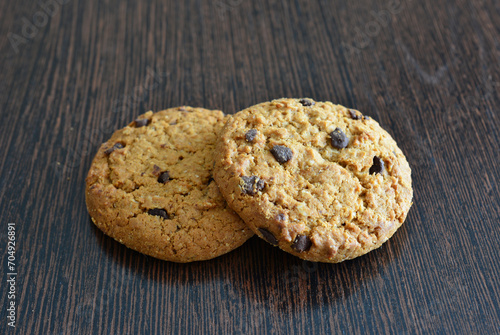 chocolate chip cookies isolated on dark wooden background