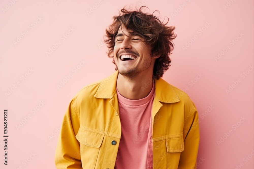Portrait of a happy young man laughing isolated over pink background. Portrait of a happy young man laughing isolated over pink background.