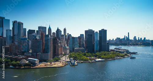 Aerial View of Lower Manhattan Architecture. Panoramic Photo of Wall Street Financial District from a Helicopter. Office Buildings Scenery with Water Transportation in the Hudson River