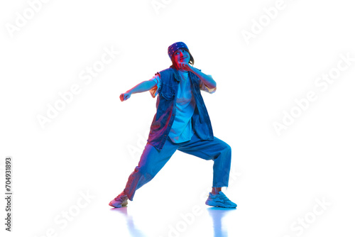 Hip hop, contemp, dance hall, street style dancer. Young girl in motion dancing isolated over white background in neon light. Concept of contemporary dance, style, youth, hobby, action, lifestyle © master1305