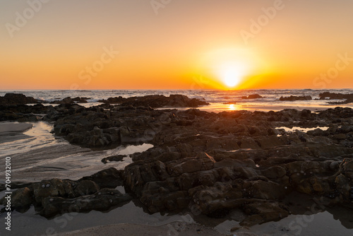 Sunset and seascape with rock formation in at Apulia beach. Parque Natural do Litoral on the north of Portugal in the vicinity of the Esposende town. photo