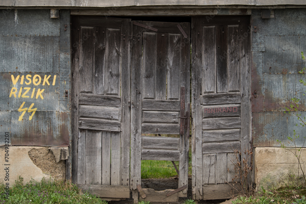 Sunja , Croatia, 05,04,2021: Old wooden rustic door on rural home wall. Sunja , Croatia, 05,04,2021: Old wooden rustic door on rural home wall.