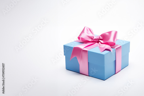 a small blue gift box with a pink bow, celebrating a birthday,