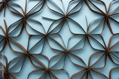  a close up of a blue wall with a pattern made out of brown strips of paper on top of it.