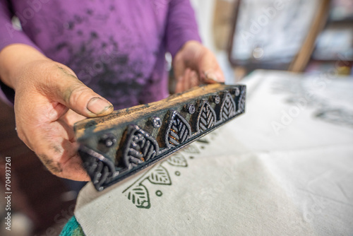Womans hand working with fabric printing mold and ink traditional writing and woodblock printing work of Kastamonu and Anatolia region.