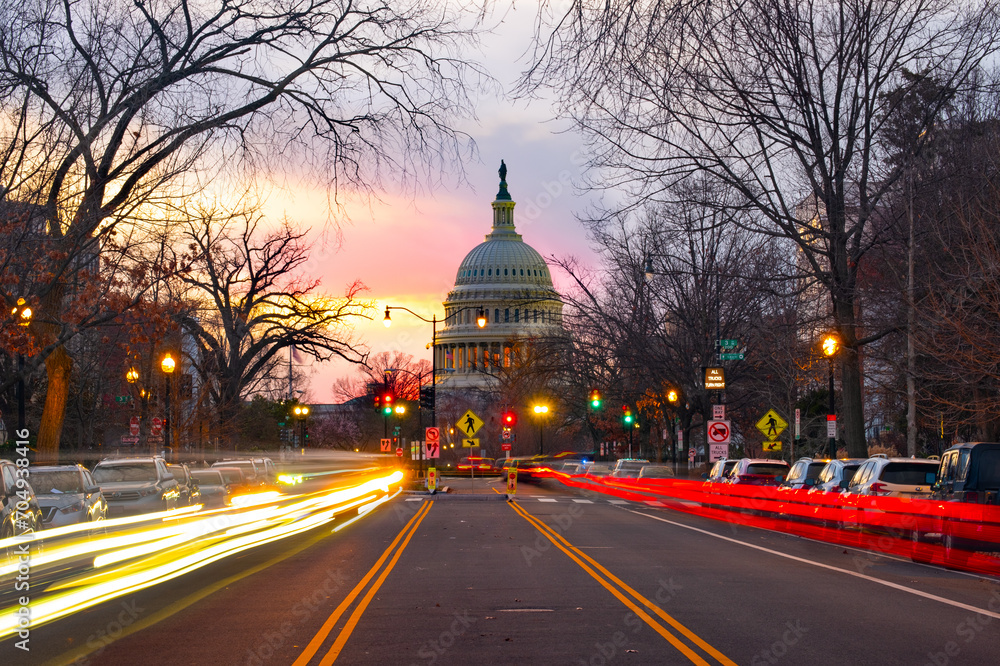 US Capitol Building at sunset with traffic moving in the foreground