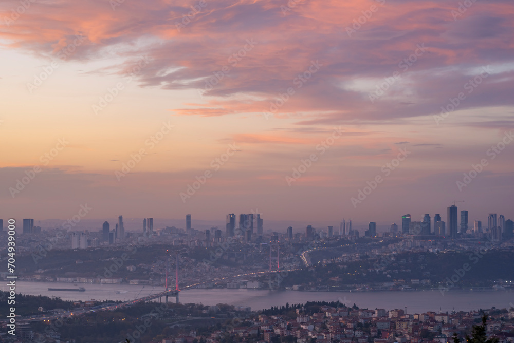 Istanbul Bosphorus Bridge at sunset and evening lights with colorful clouds in the sky