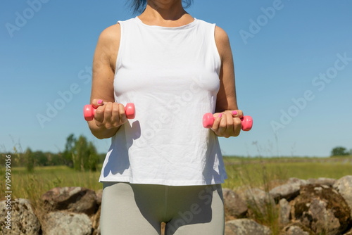 Woman does fitness in the fresh air