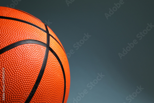 One orange basketball ball on dark grey background, closeup. Space for text © New Africa