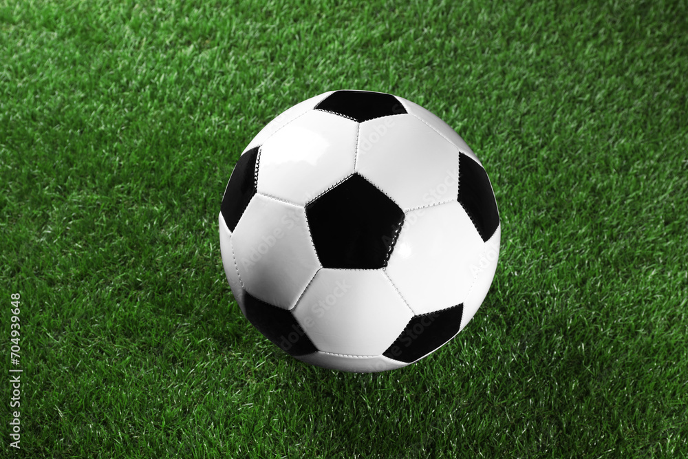 One soccer ball on green grass. Sports equipment