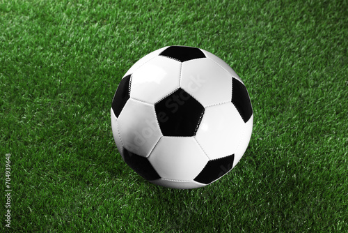 One soccer ball on green grass. Sports equipment