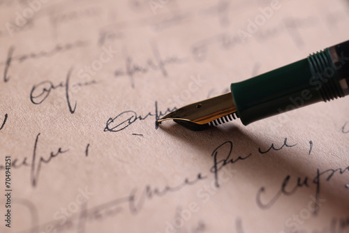 Writing letter with elegant fountain pen, closeup