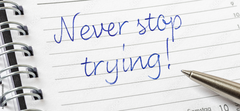 Never stop trying written on a calendar page Never stop trying written on a calendar page