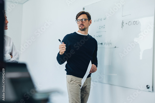 Professional project manager brainstorming with his team in a business meeting photo