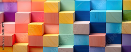 Wooden blocks in various colors like red  blue  green   orange  violet. Rainbow colors on wood cubes.