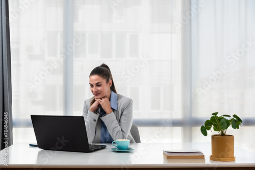 Young businesswoman adjusting to her new workplace after being promoted to a better position in a new office in a global business company.