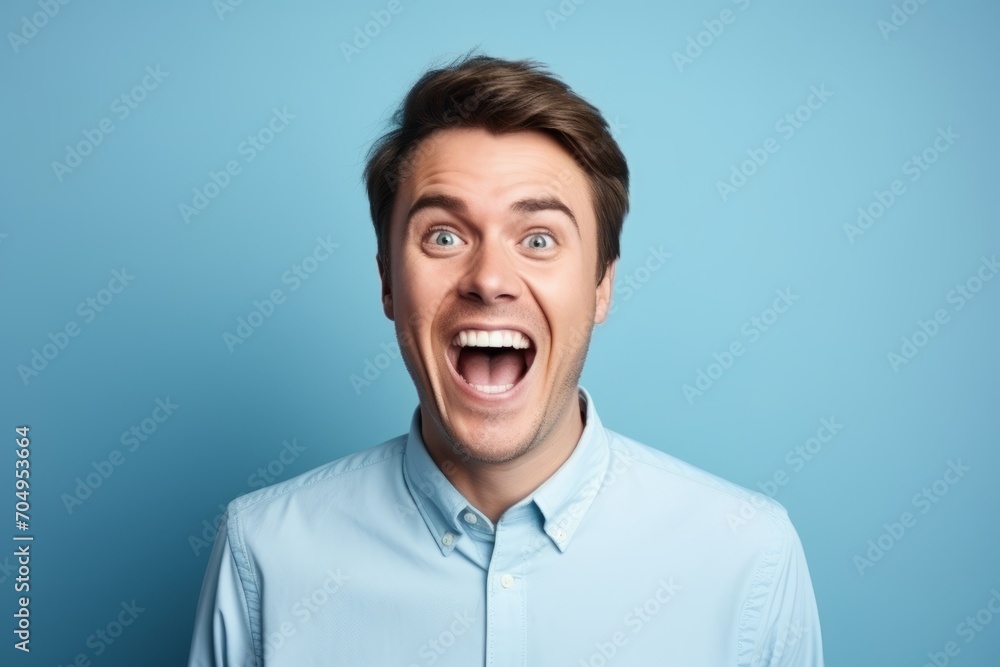 Portrait of a young surprised man on blue background. Emotions Portrait of a young surprised man on blue background. Emotions