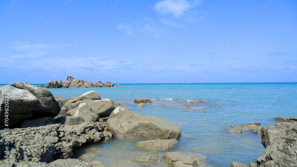 Natural View Of Blue Sea Water And Piles Of Large Coral Rocks, At Tanjung Kalian, Indonesia