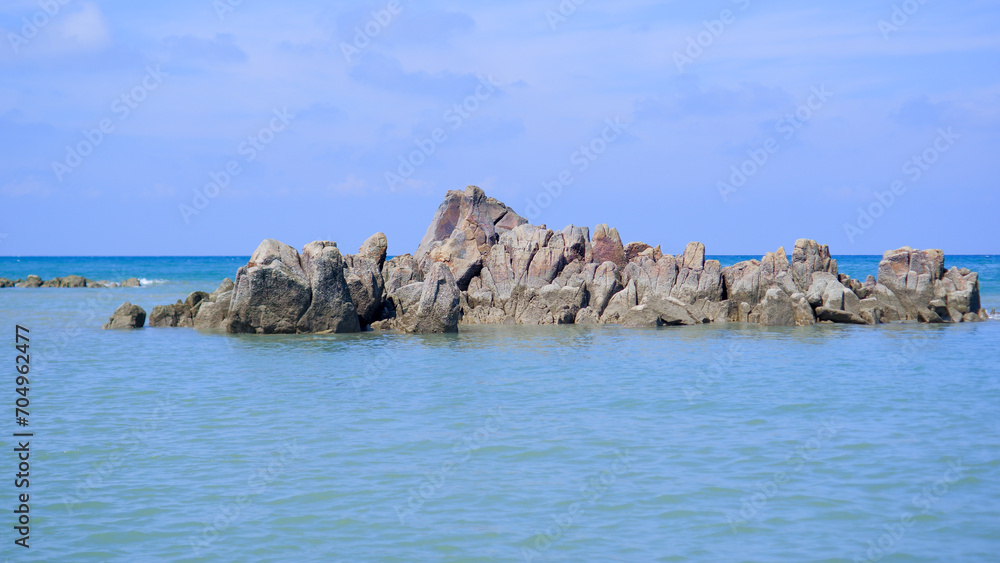 Charming Natural View Of Piles Of Rock Formations In The Middle Of Blue Sea Water, On Tanjung Kalian Beach, Indonesia