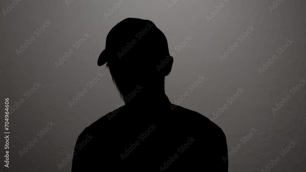 Silhouette of male secret agent hiding face while speaking in anonymous interview. Silhouette of male secret agent hiding face while speaking in anonymous interview.
