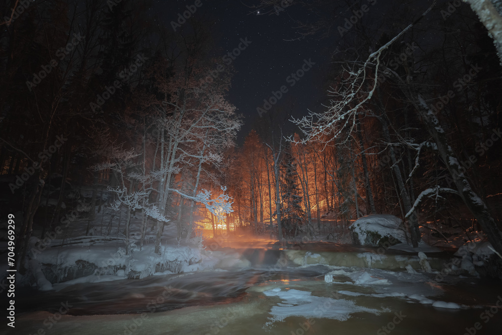 Nature of Estonia in winter.  Night scene, frozen forest river.