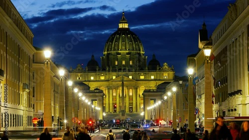 Slow motion time lapse Vatican in Rome Ancient city in Europe. Art and culture. of St. Peter's Basilica in the Vatican, the Pope's church, from Via della Conciliazione at night with lights photo