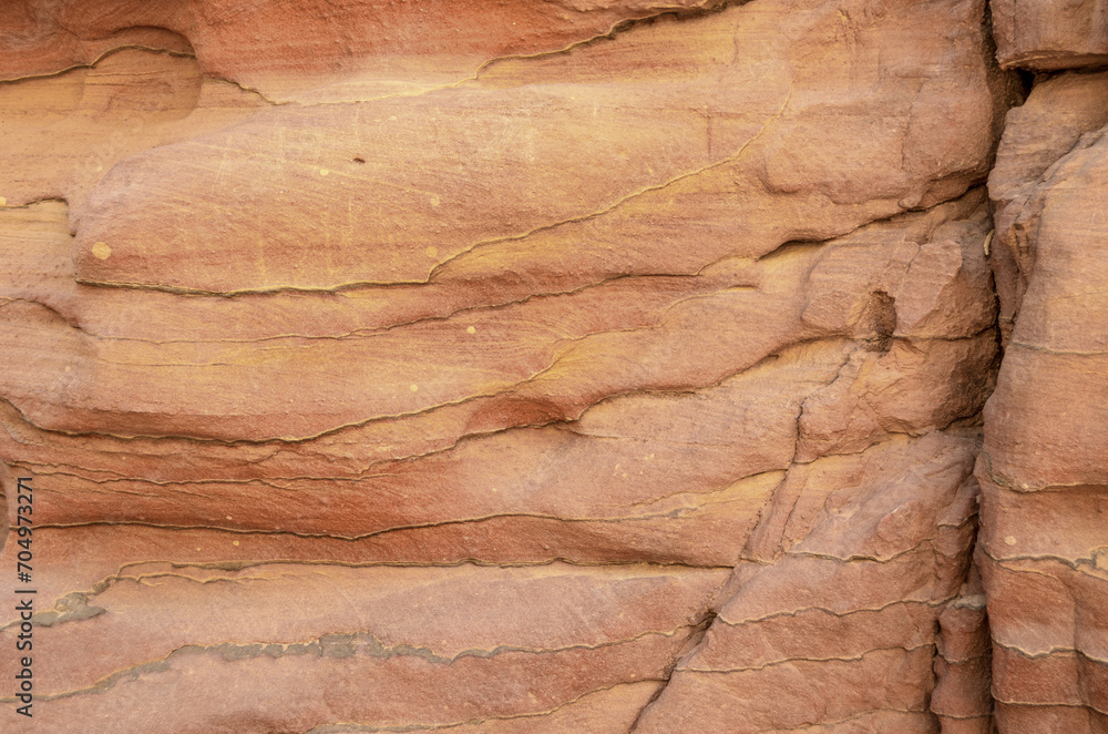 Naklejka premium texture of orange stone rock in a colored canyon close up
