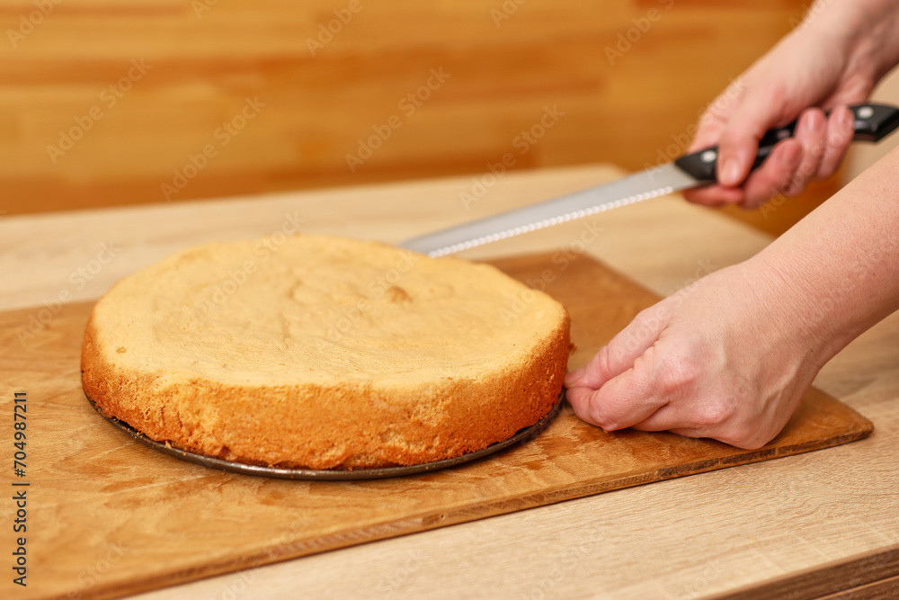 A freshly baked cake is cut in half. Cooking a festive pie at home