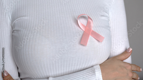 Wallpaper Mural A woman in a white sweater with a pink fly in support of breast cancer patients. Torontodigital.ca