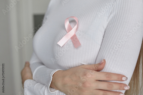 Wallpaper Mural A woman in a white sweater with a pink fly in support of breast cancer patients. Torontodigital.ca