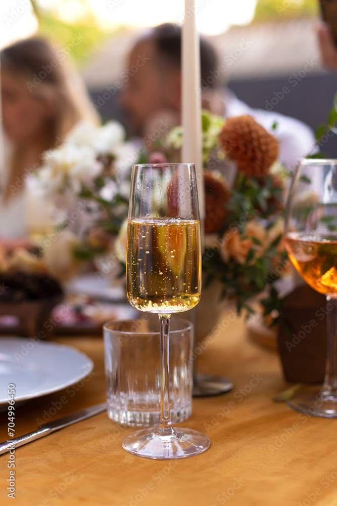 Fototapeta premium Wedding table for guests, decorated with candles, are served with cutlery and crockery and covered with yellow tablecloth
