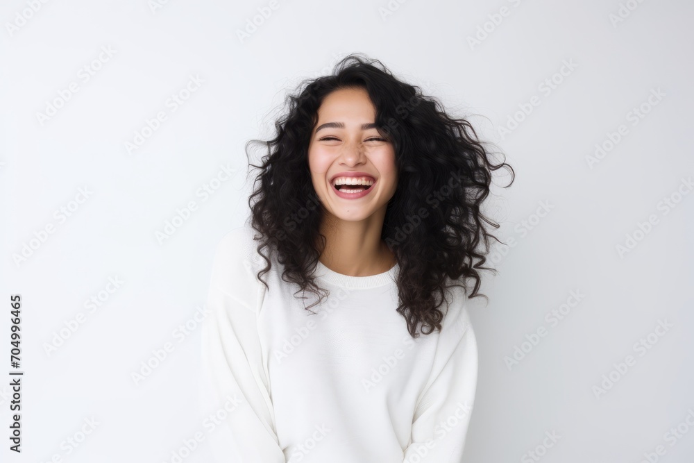 Portrait of beautiful young woman with curly hair laughing against white background Portrait of beautiful young woman with curly hair laughing against white background