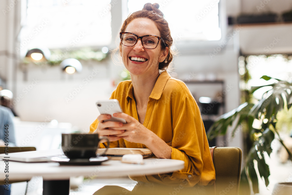 Professional woman using a mobile phone in restaurant