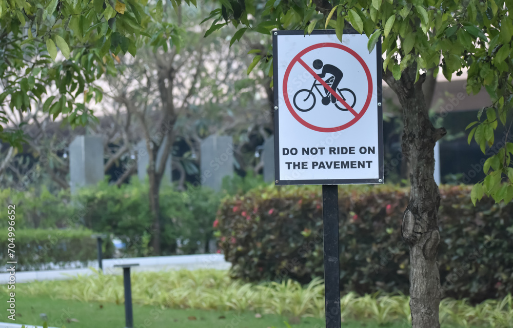 A closeup sign board banning movement of cycle or vehicle on pavement. A closeup sign board banning movement of cycle or vehicle on pavement.