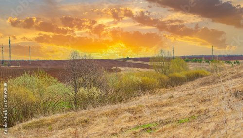 Witness the stunning beauty of nature's colors during sunset. Enjoy the peaceful and serene atmosphere as the day comes to an end. Take photos of the golden light falling onto the plowed field.