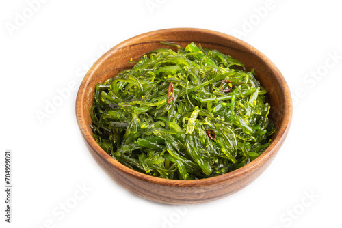 Chuka seaweed salad in brown wooden bowl isolated on white. Side view