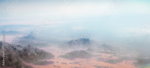 panorama from the airplane window to the mountains and desert in Egypt