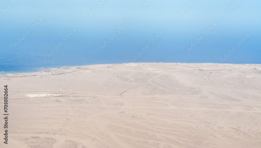 view from the plane window of the Red Sea and the desert in Egypt