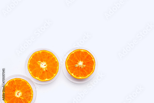 Vitamin C pills with  fresh orange citrus fruit isolated on white background.