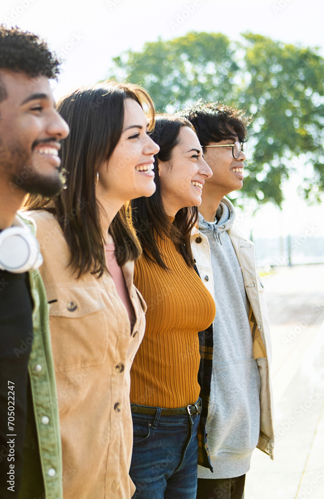 © Xavier Lorenzo - Vertical photo. Side view of united multiracial people hugging each other in cooperation. Group of happy young friends supporting together in line. Cooperation, teamwork and unity concept © Xavier Lorenzo - Vertical photo. Side view of united multiracial people hugging each other in cooperation. Group of happy young friends supporting together in line. Cooperation, teamwork and unity concept