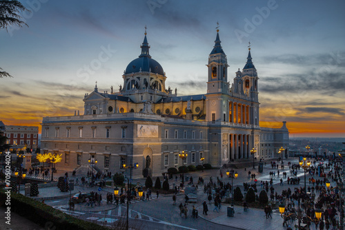 Madrid, Spain 28-12-2022 The Almudena Cathedral during a colorful sunset, it is the most important  and Catholic religious building in Madrid and a visit is free of charge except for the crypt   photo