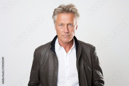 Portrait of mature man with grey hair wearing a leather jacket.