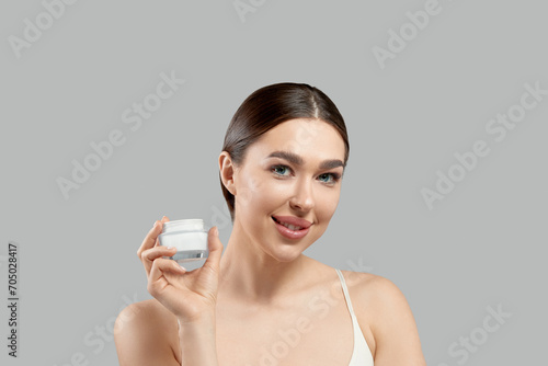 Beautiful Woman Face Skin Care. Portrait Of Attractive Young Female Applying Cosmetics Cream . Closeup Of Beauty Smiling Girl With Natural Makeup And Fresh Skin. Face Skin Care.